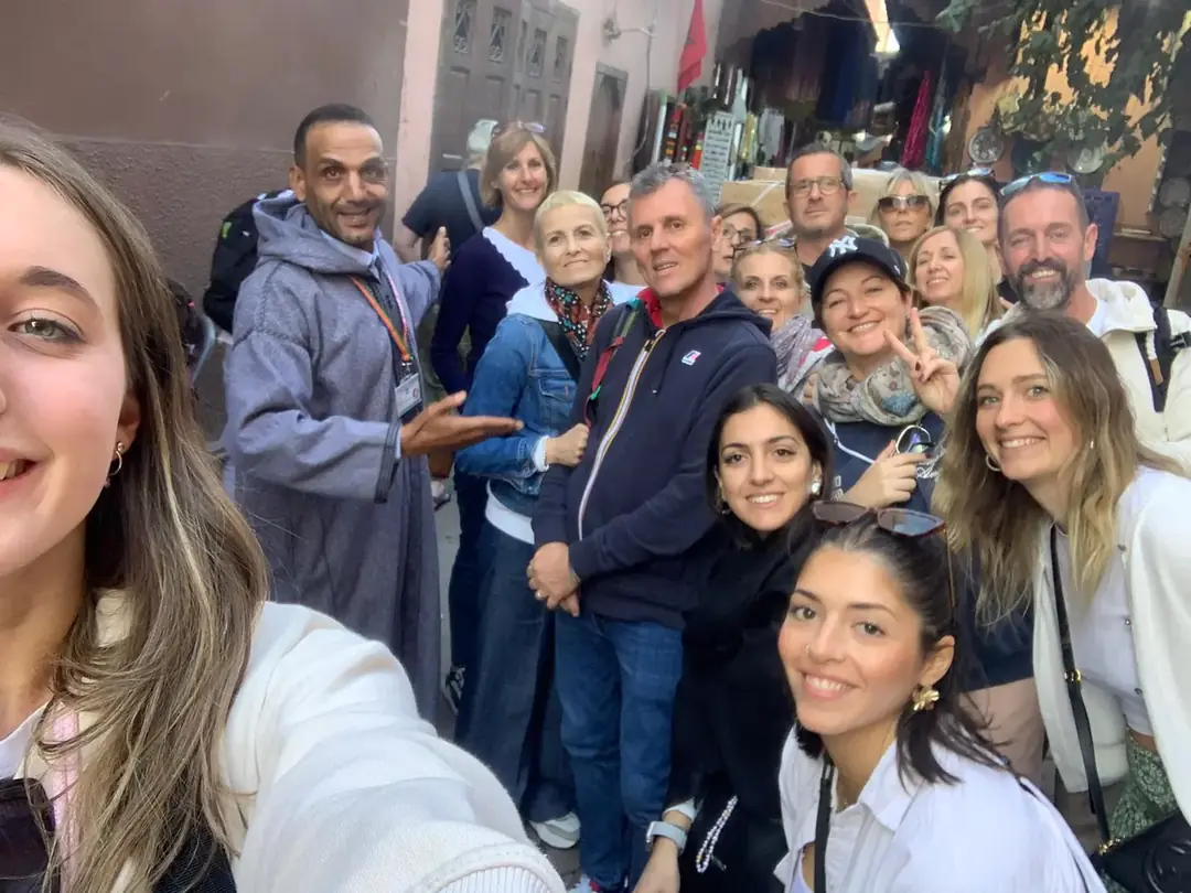 Youssef and a group of friends taking a selfie in a medina alley